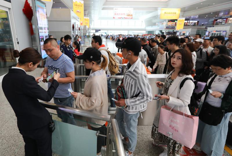 图为旅客在贵阳北站检票上车\新华社